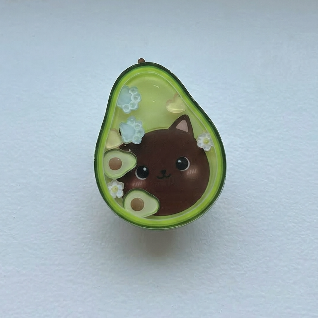 Avocado-shaped object with a cat design on a white background
