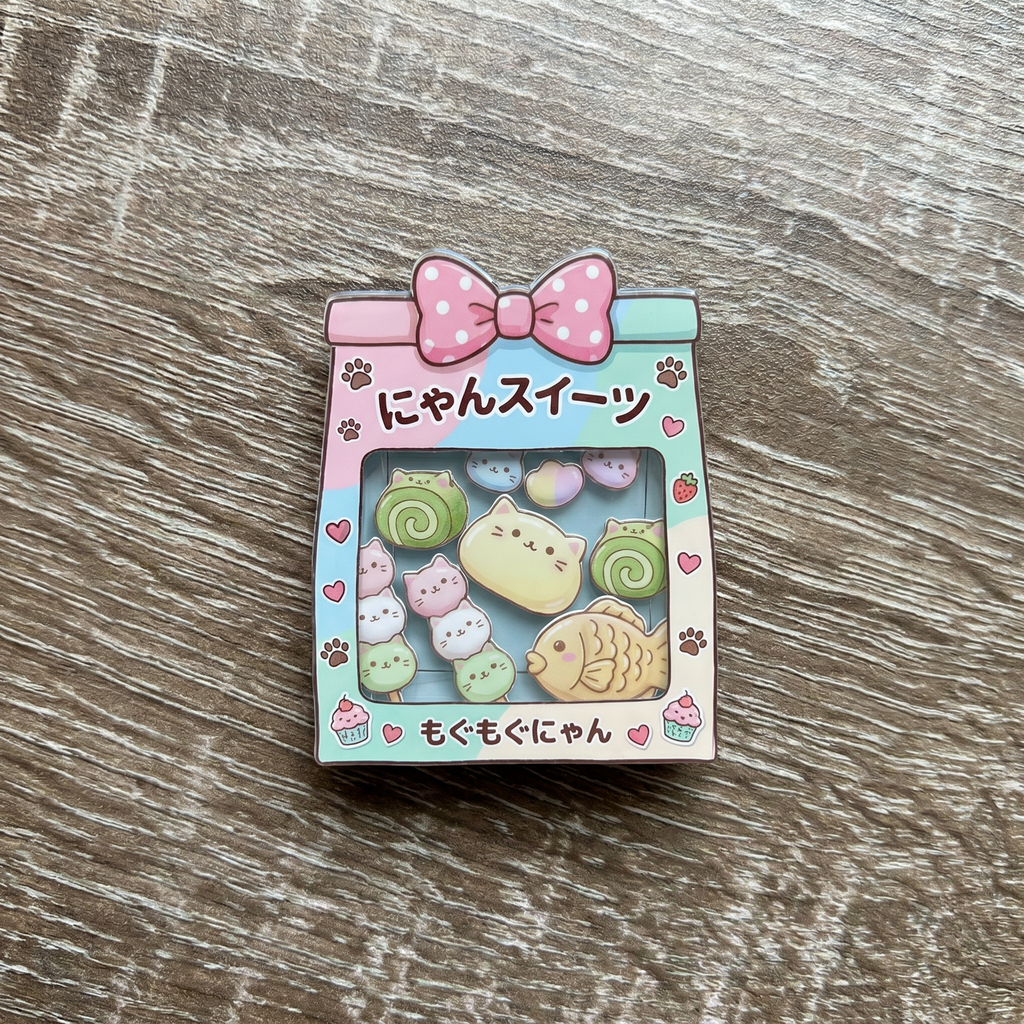 Cute shaker phone grip with kawaii Japanese cat pastries on a wooden surface