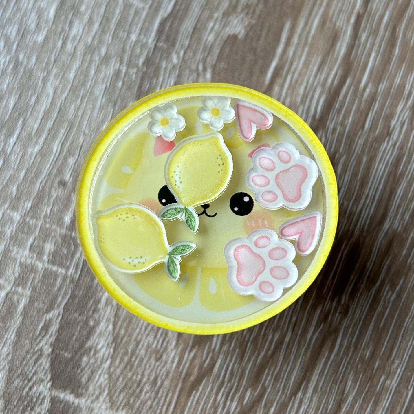 kawaii lemon cat shaker phone grip on a wooden surface